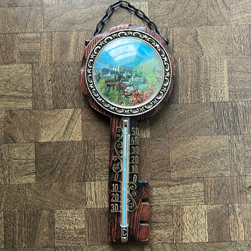 Vintage wooden key shaped wall hanging thermometer Swiss Alps scenery